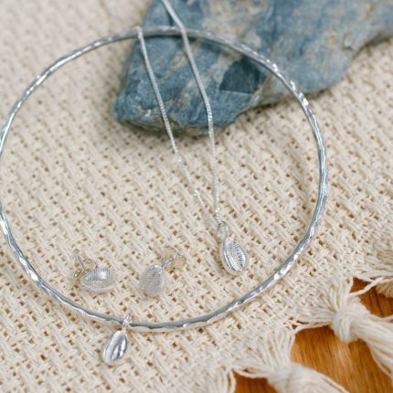 Bangle, pendant and stud earring set of sterling silver cowrie shells by Porth Jewellery