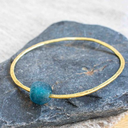 Brass bangle with teal bottle bead by Sarah Drew