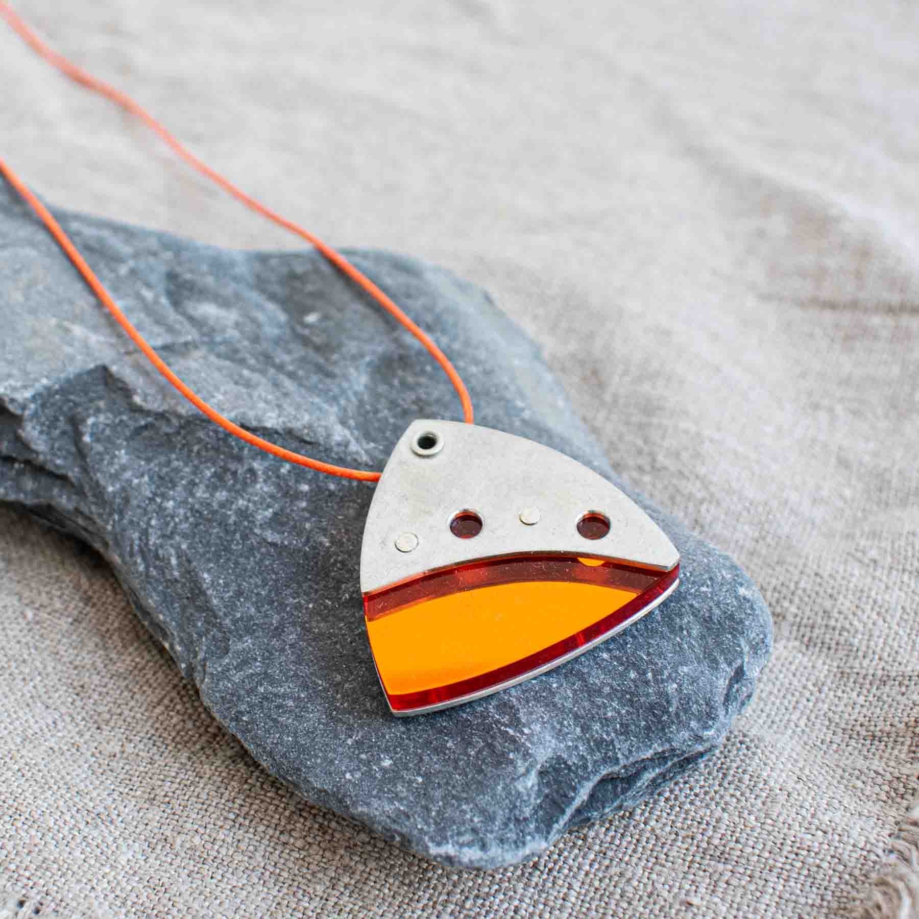 Orange perspex and pewter contemporary pendant on waxed orange cord by Ceciel Van Oevelen