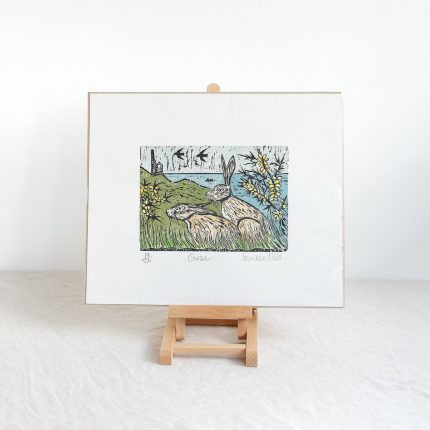 Woodcut print of two hares on the coast of Cornwall with a tin mine in the background by Louisa Ellis