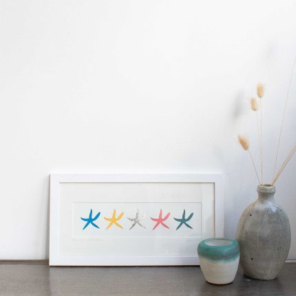 Framed paper cut picture with a row of 5 coloured starfish by Cornish Paper Cut Art