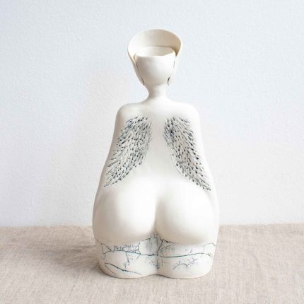 Reverse of porcelain sculpture of a lady with wing detail by Nicky Stone