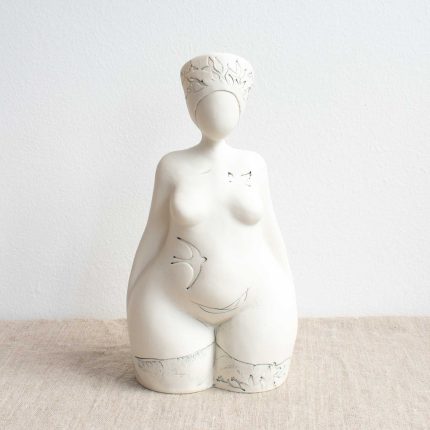 Porcelain sculpture of a lady with headdress and bird detail by Nicky Stone