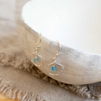 Pair of blue topaz and silver wire circle drop earrings by Sarah de Larrinaga