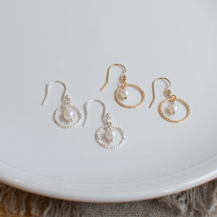 Pairs of pearl and wire circle drop earrings by Sarah de Larrinaga