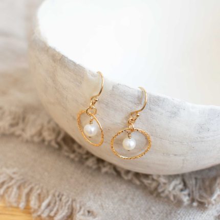 Pair of pearl and gold filled wire circle drop earrings by Sarah de Larrinaga