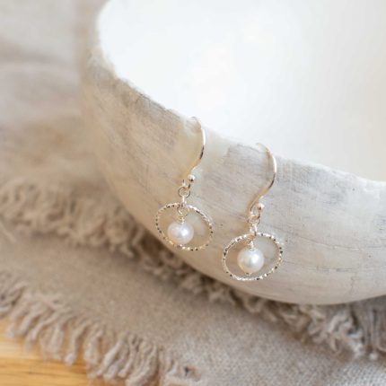 Pair of pearl and silver wire circle drop earrings by Sarah de Larrinaga