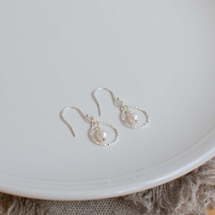 Pair of pearl and silver wire circle drop earrings by Sarah de Larrinaga