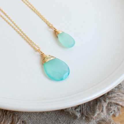 Two sea green chalcedony and gold filled wire wrapped pendants of different sizes by Sarah de Larrinaga