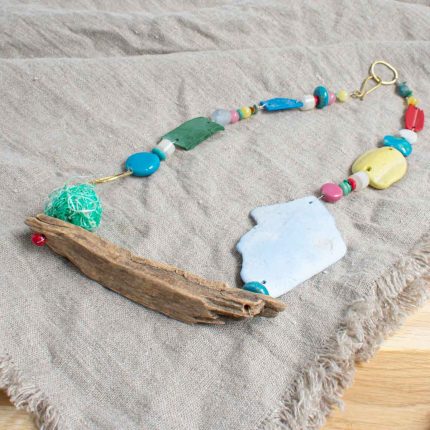 Statement necklace made of beach plastic, driftwood and brass by Sarah Drew