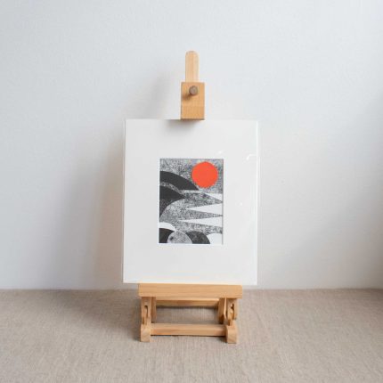 Original collage of a black and white coast with orange sun, with white mount by Riverbird Studio