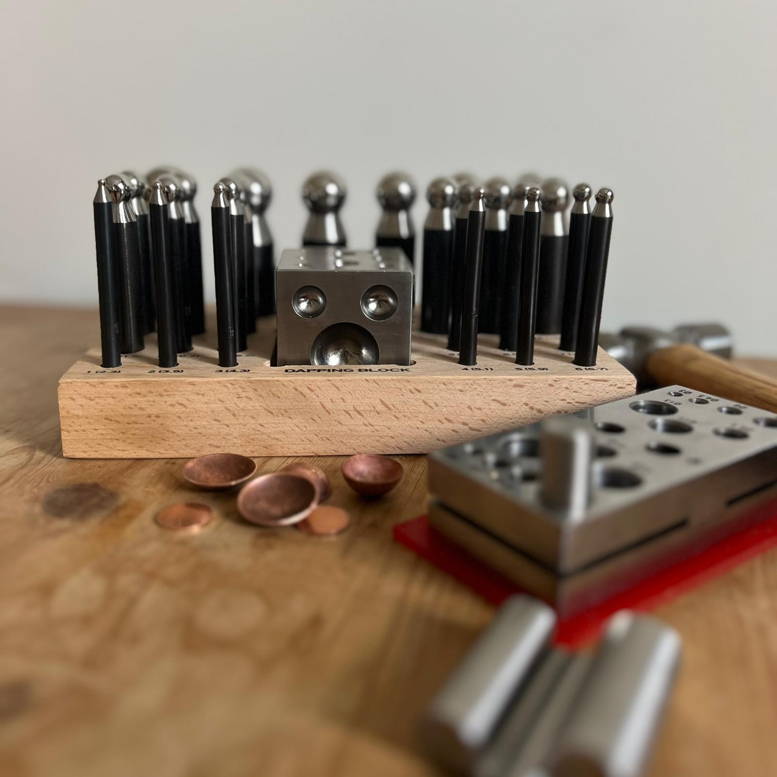 Doming tools, copper blanks and hammer used in Intermediate Jewellery course with Porth Jewellery