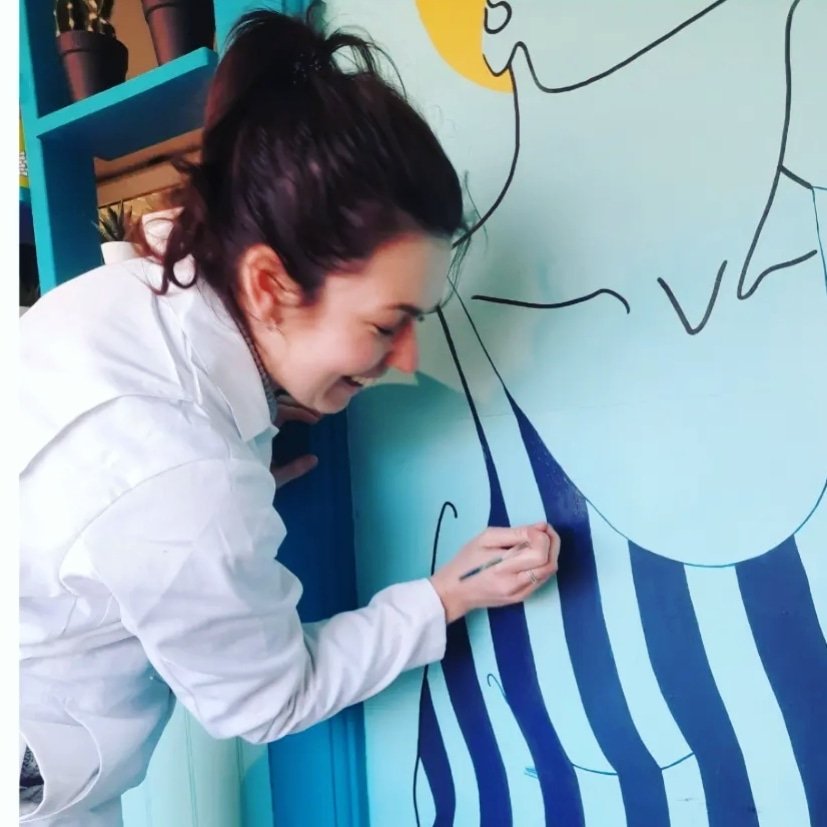 Woman painting a striped swimsuit illustration