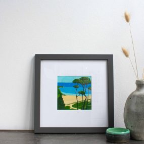 Painting Of Trees On The Coast With Blue Sky In White Mount And Grey Frame On Table With Vase By Karen Hemsley-Biggs