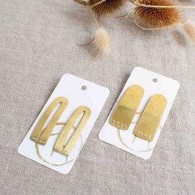 Two Pairs Of Large Brass Stud Earrings With Silver Dots Which Look Like Paws Handcrafted By Razmaker On A Linen Tablecloth With Teasels