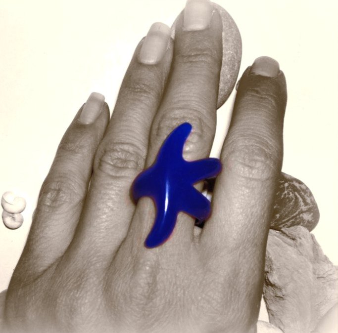 Blue wax carved sea star ring master on hand