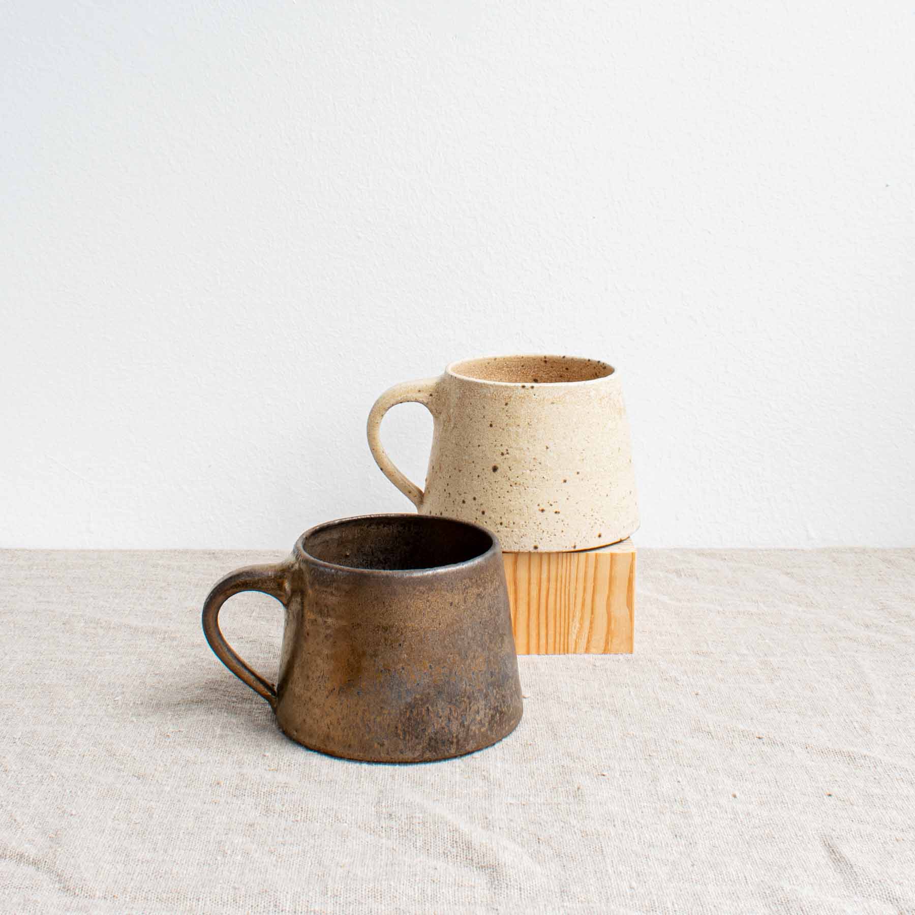 white and black medium coffee mugs